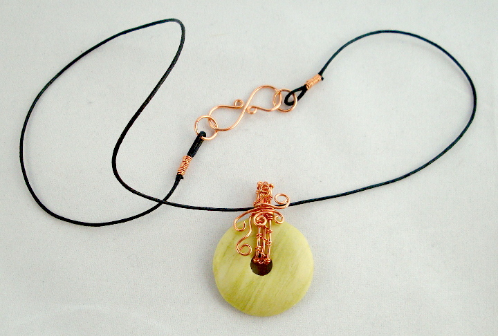 Stone donut pendent wrapped with copper 1