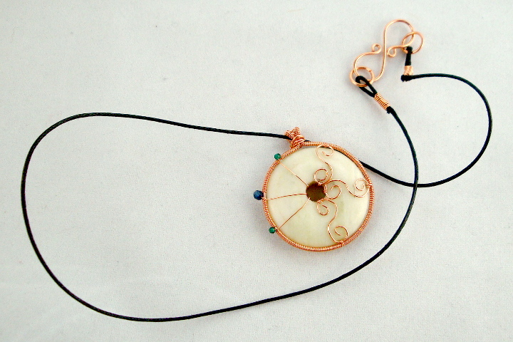 Stone donut pendent wrapped with copper and crystals 1