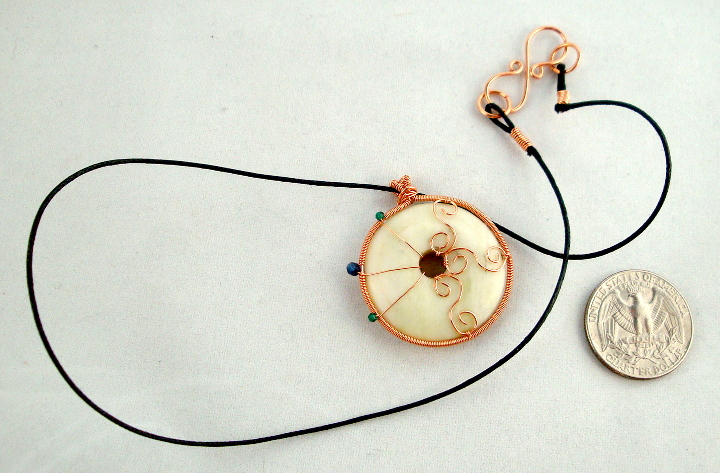 Stone donut pendent wrapped with copper and crystals 1