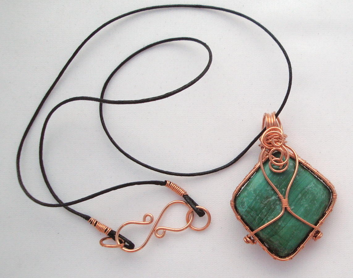 Green stone wrapped with copper wire