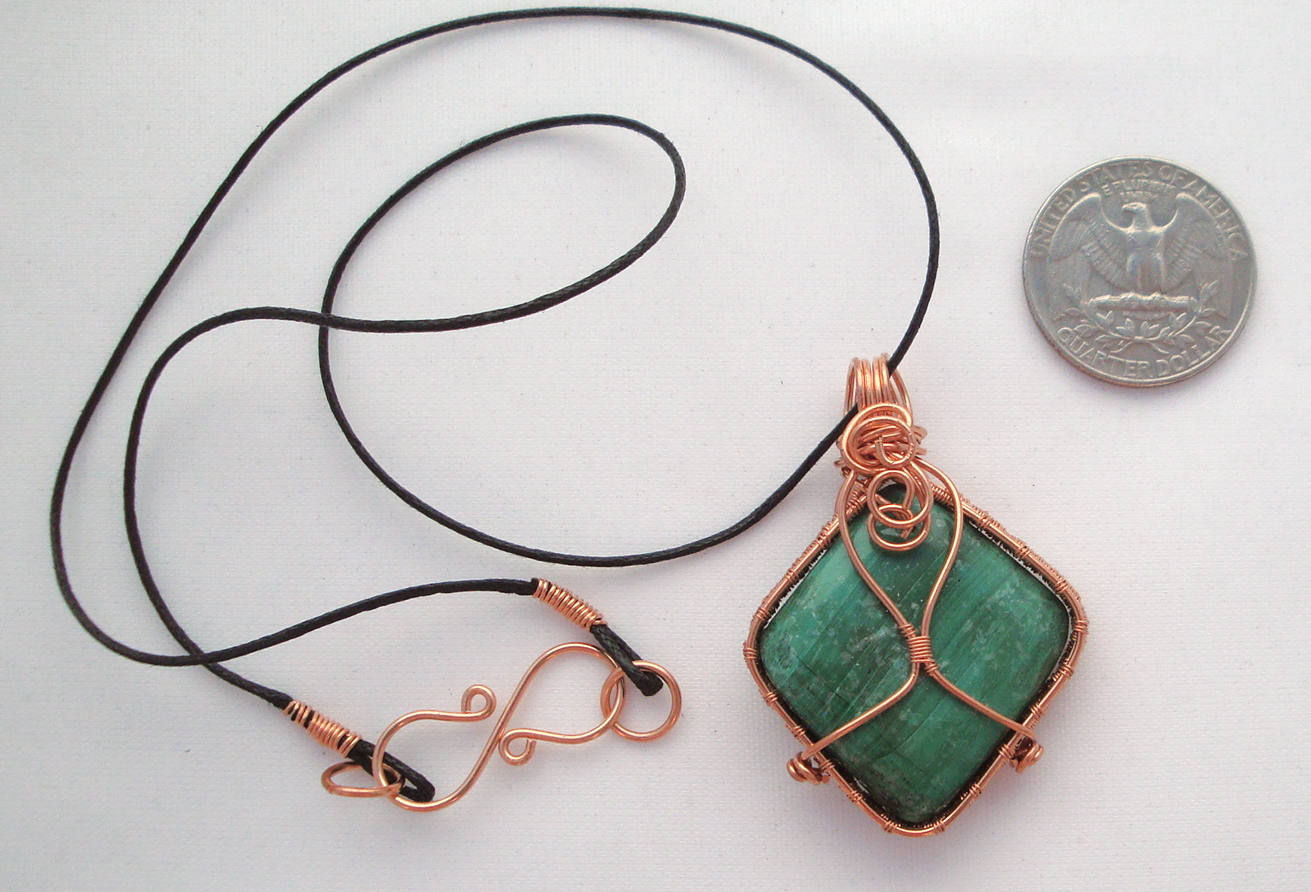 Green stone wrapped with copper wire