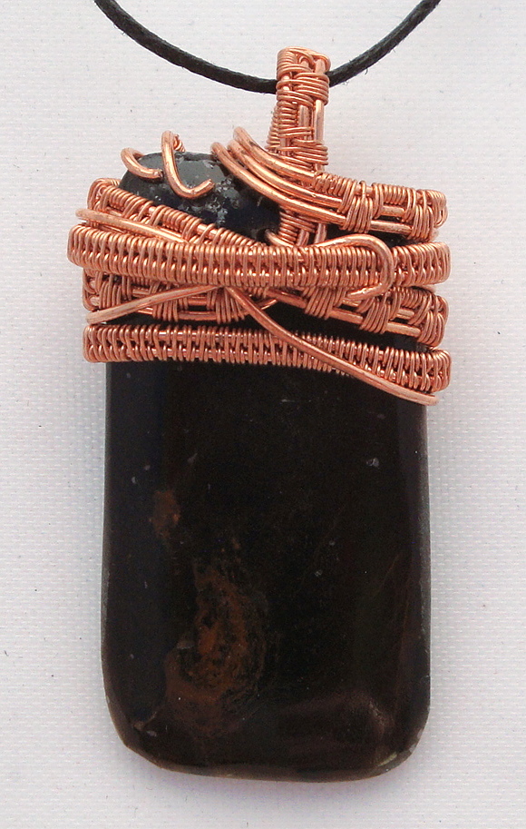 Black stone with brown swirls wrapped with copper wire