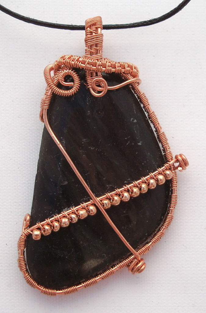 Black stone wrapped with copper wire