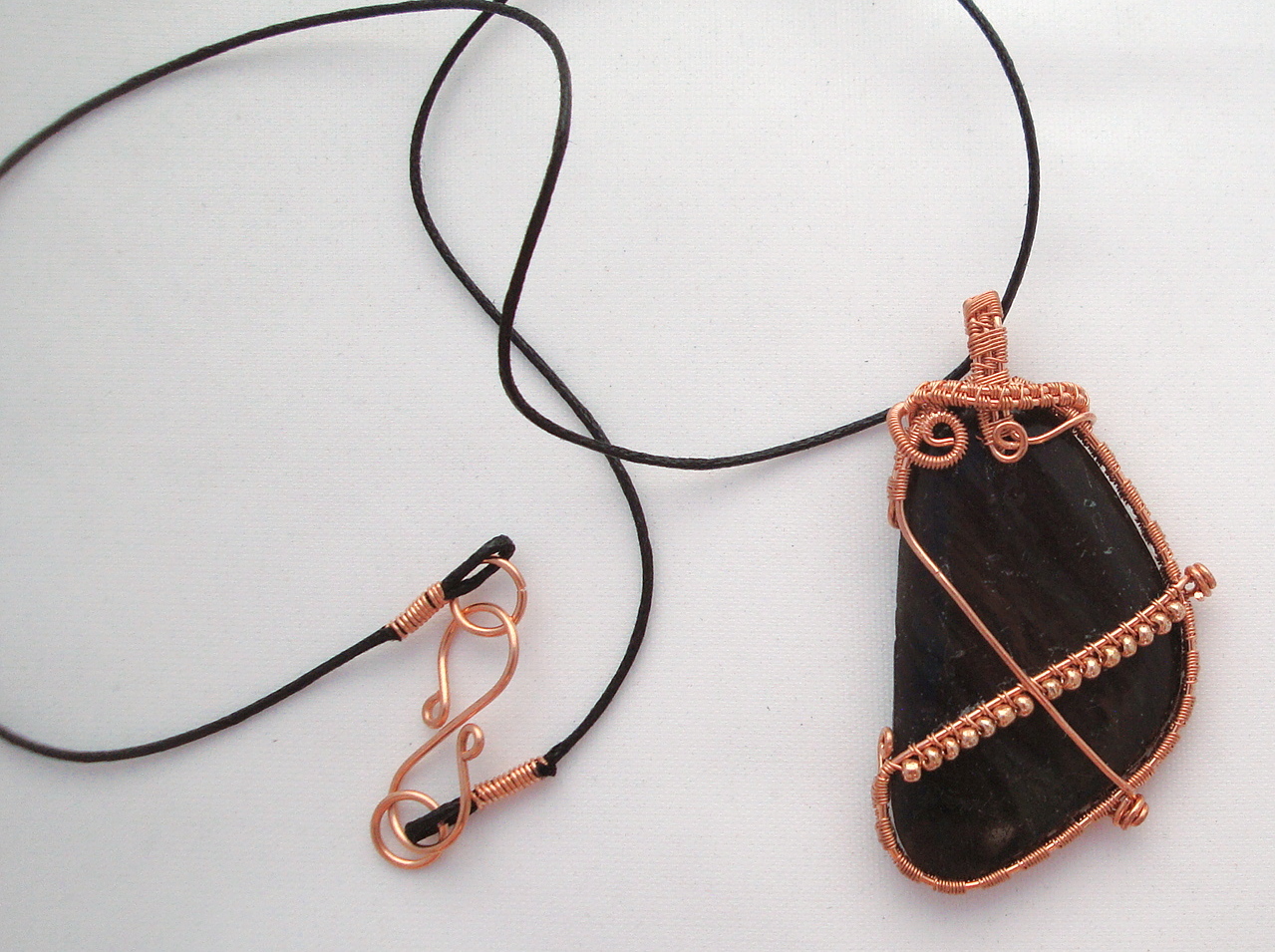 Black stone wrapped with copper wire
