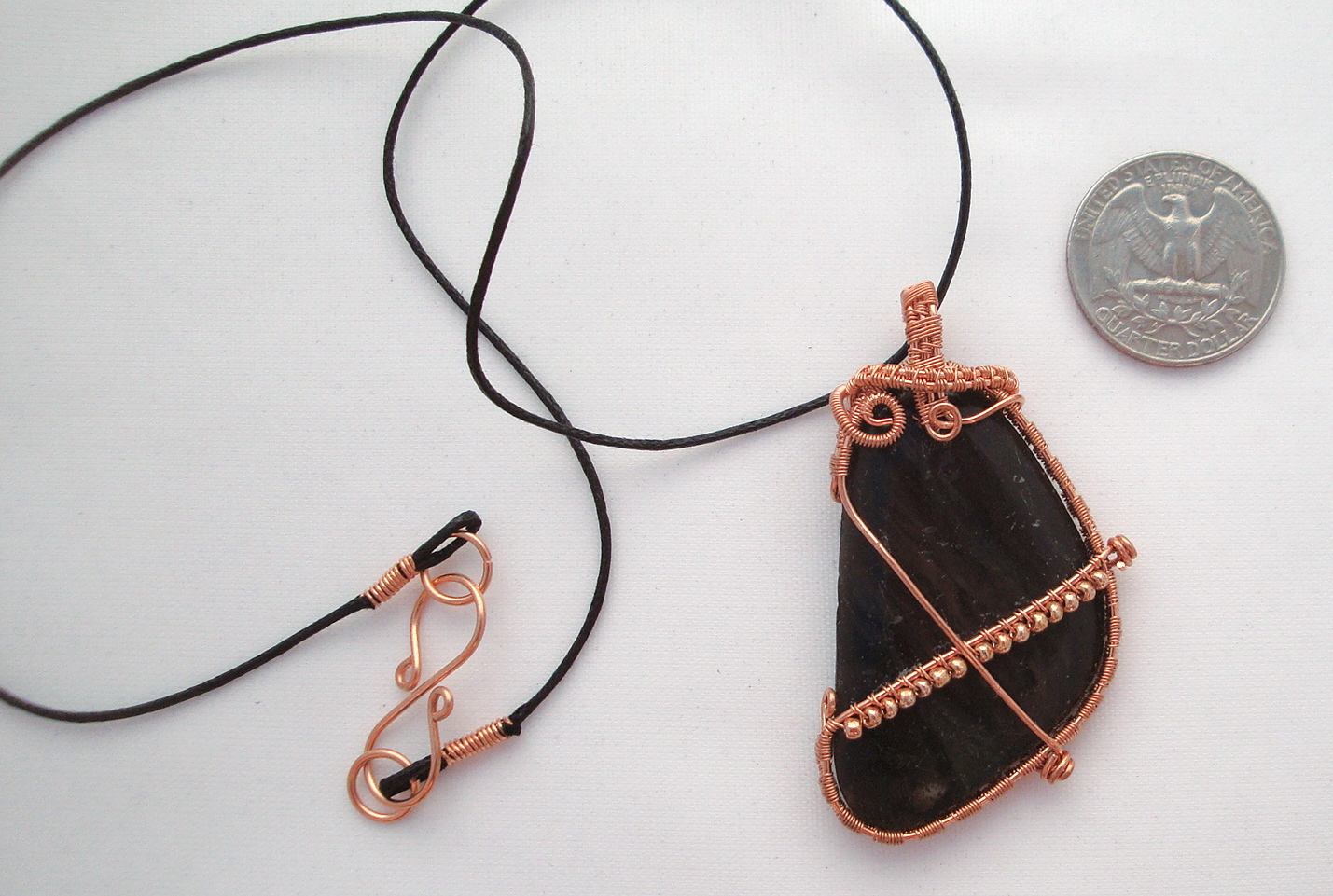 Black stone wrapped with copper wire