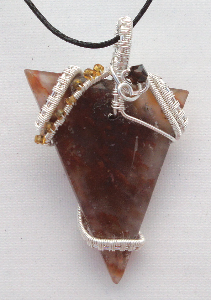 Clear-brown stone wrapped with silver wire