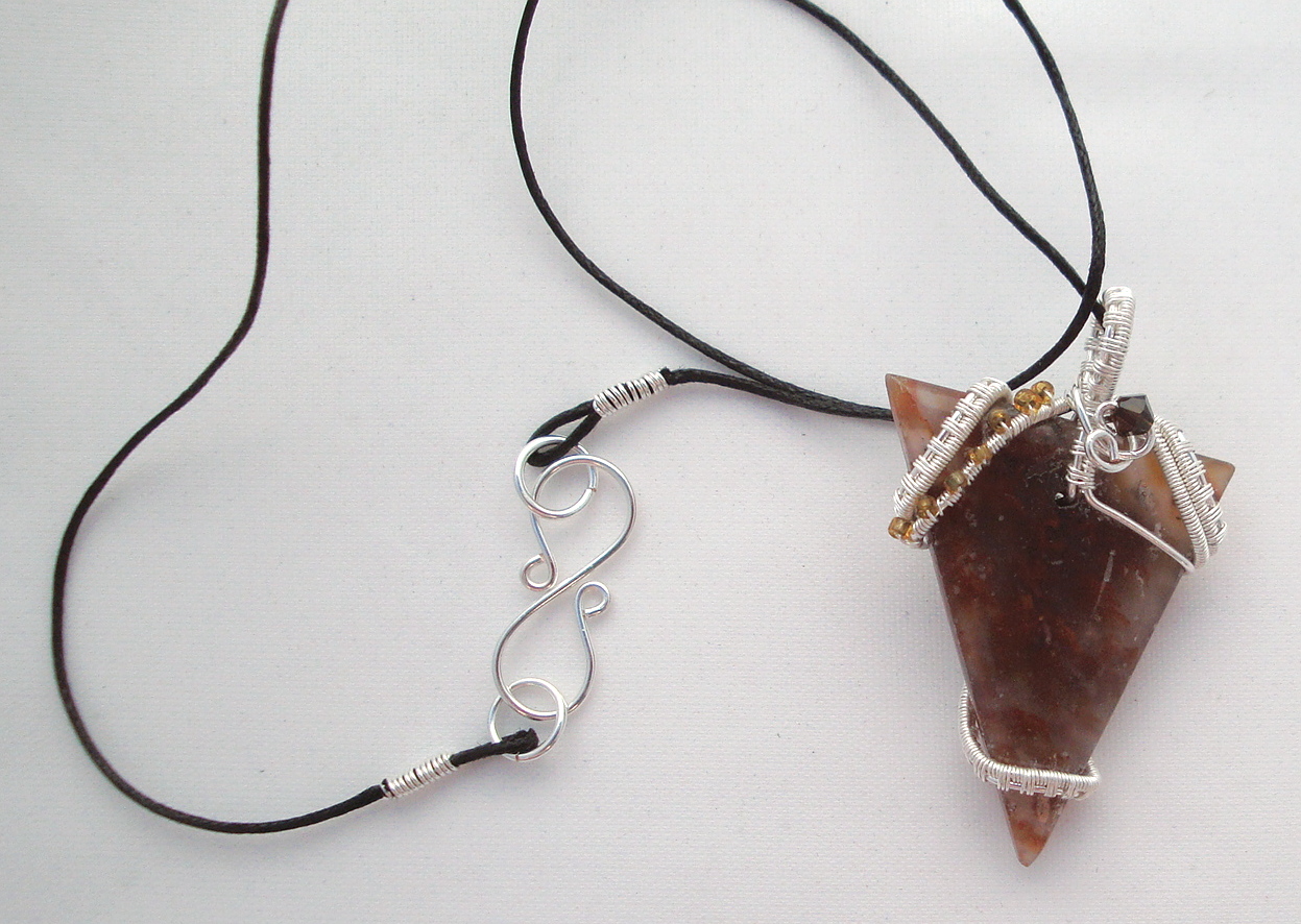 Clear-brown stone wrapped with silver wire