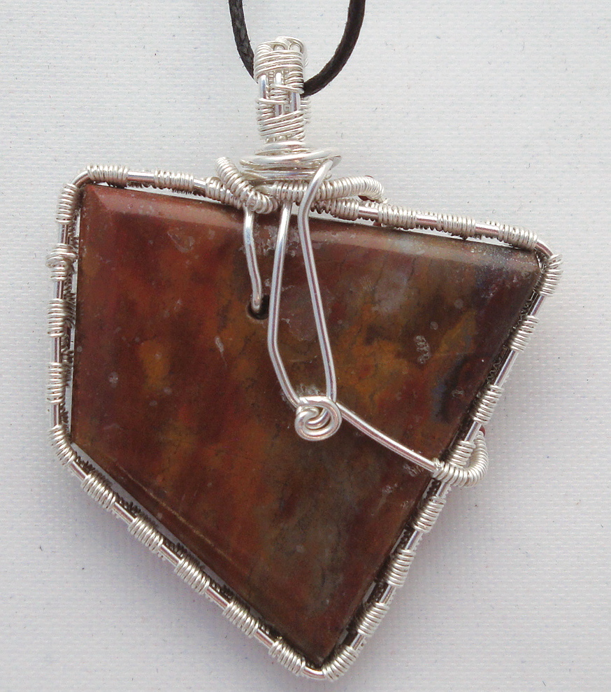 Reddish-brown stone wrapped with silver wire