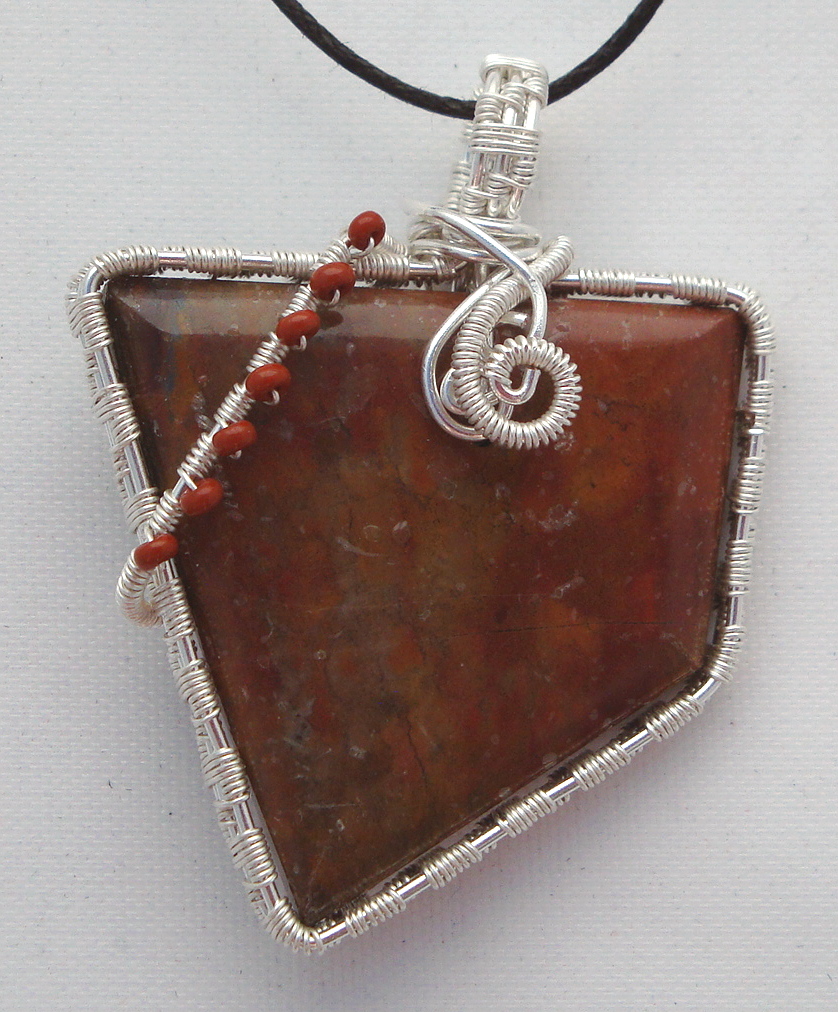 Reddish-brown stone wrapped with silver wire