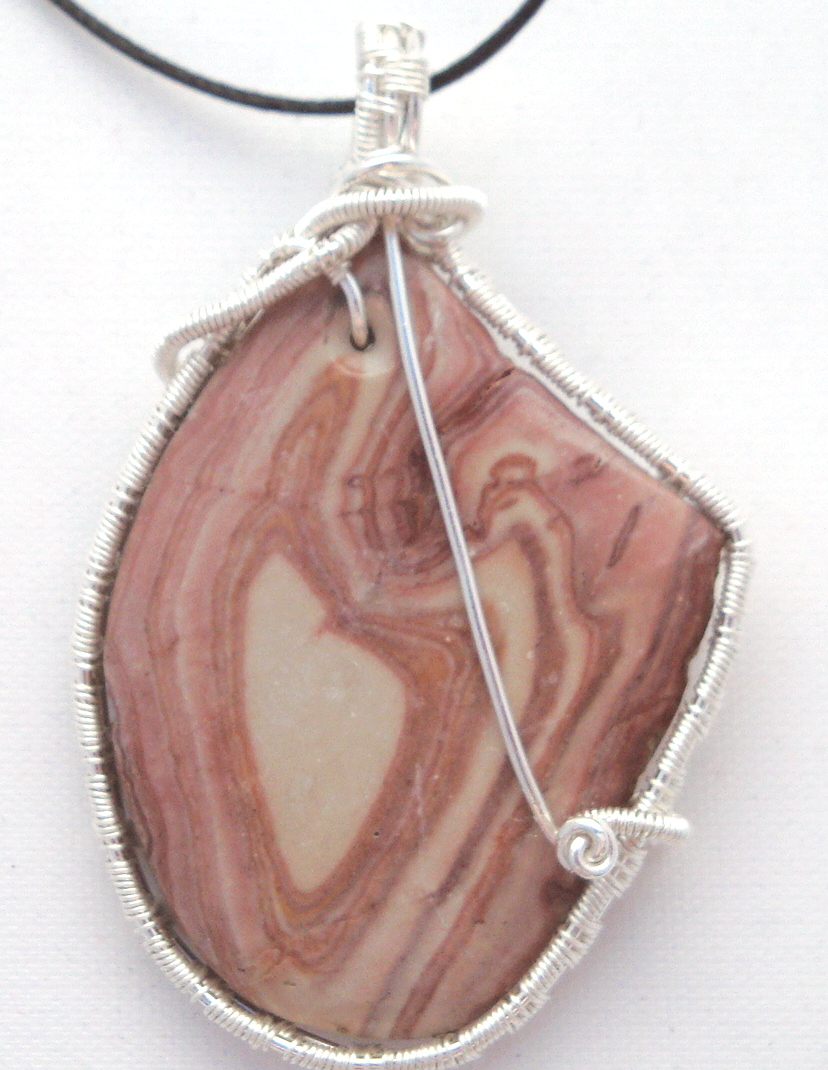 Pink-white swirled stone wrapped with silver wire