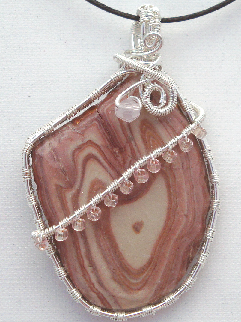 Pink-white swirled stone wrapped with silver wire