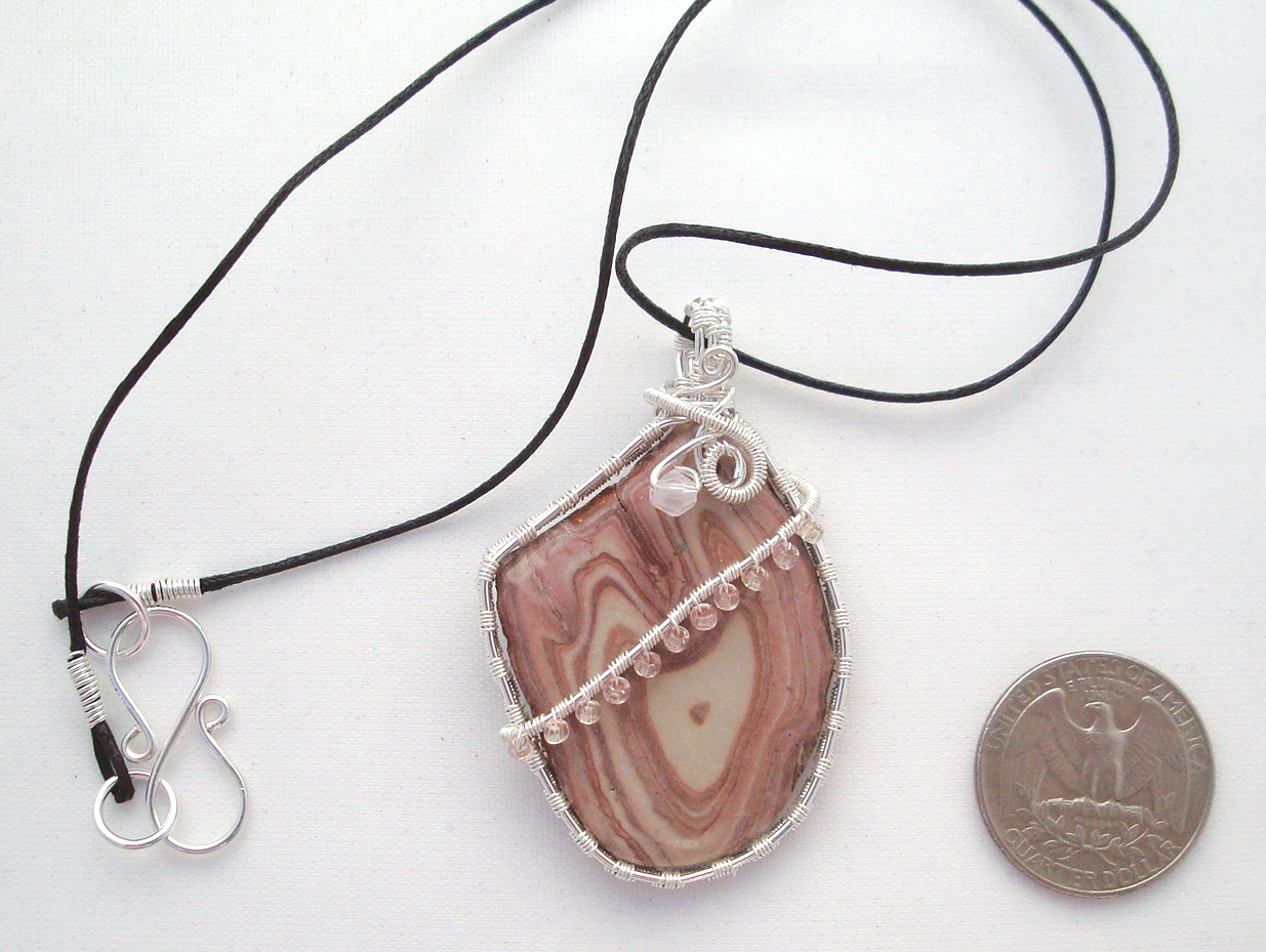 Pink-white swirled stone wrapped with silver wire