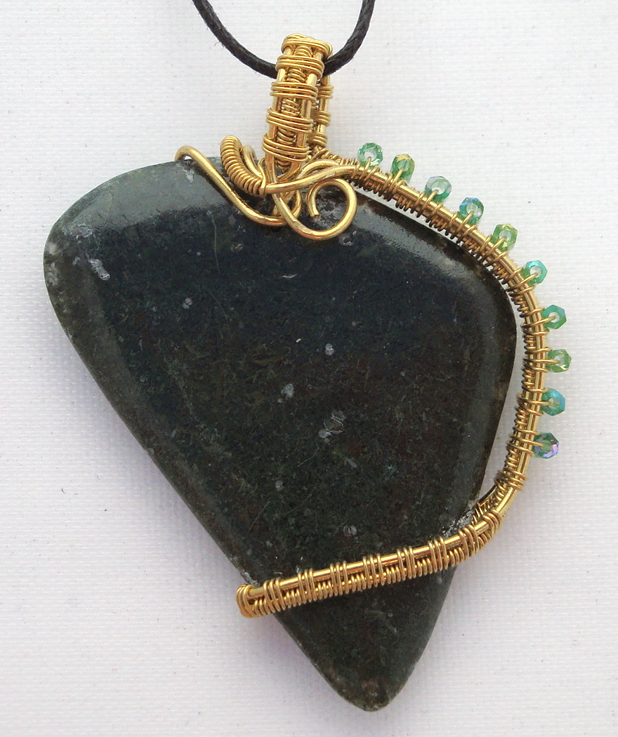 Dark green stone wrapped with bronze wire