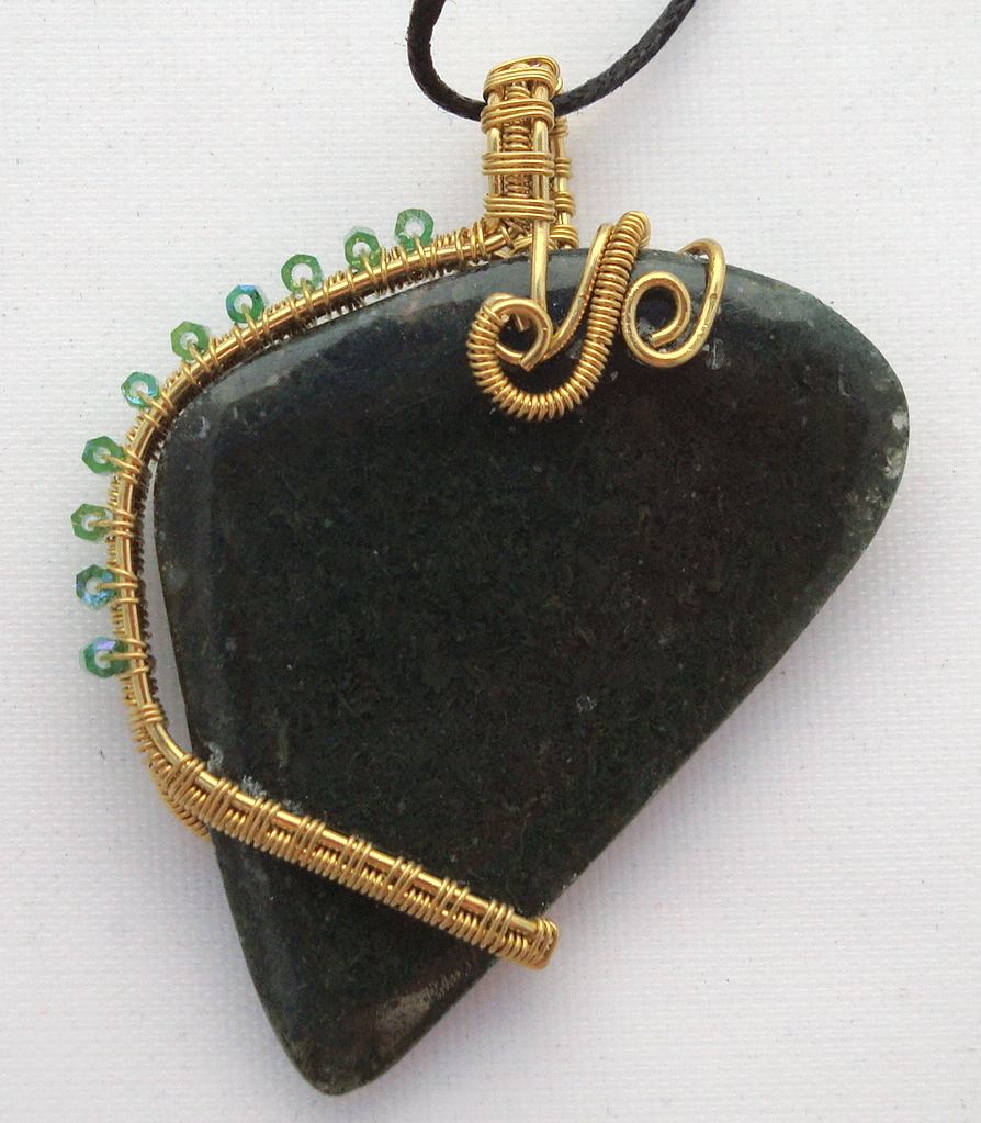 Dark green stone wrapped with bronze wire