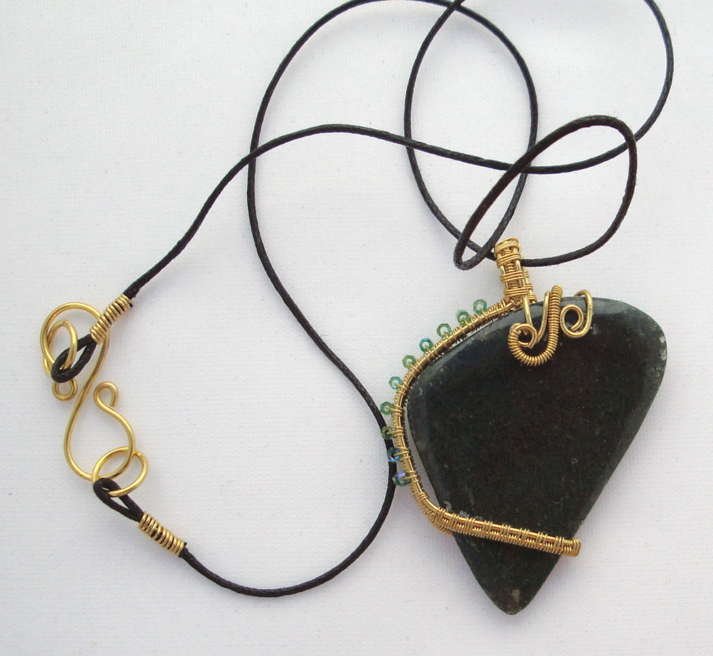 Dark green stone wrapped with bronze wire