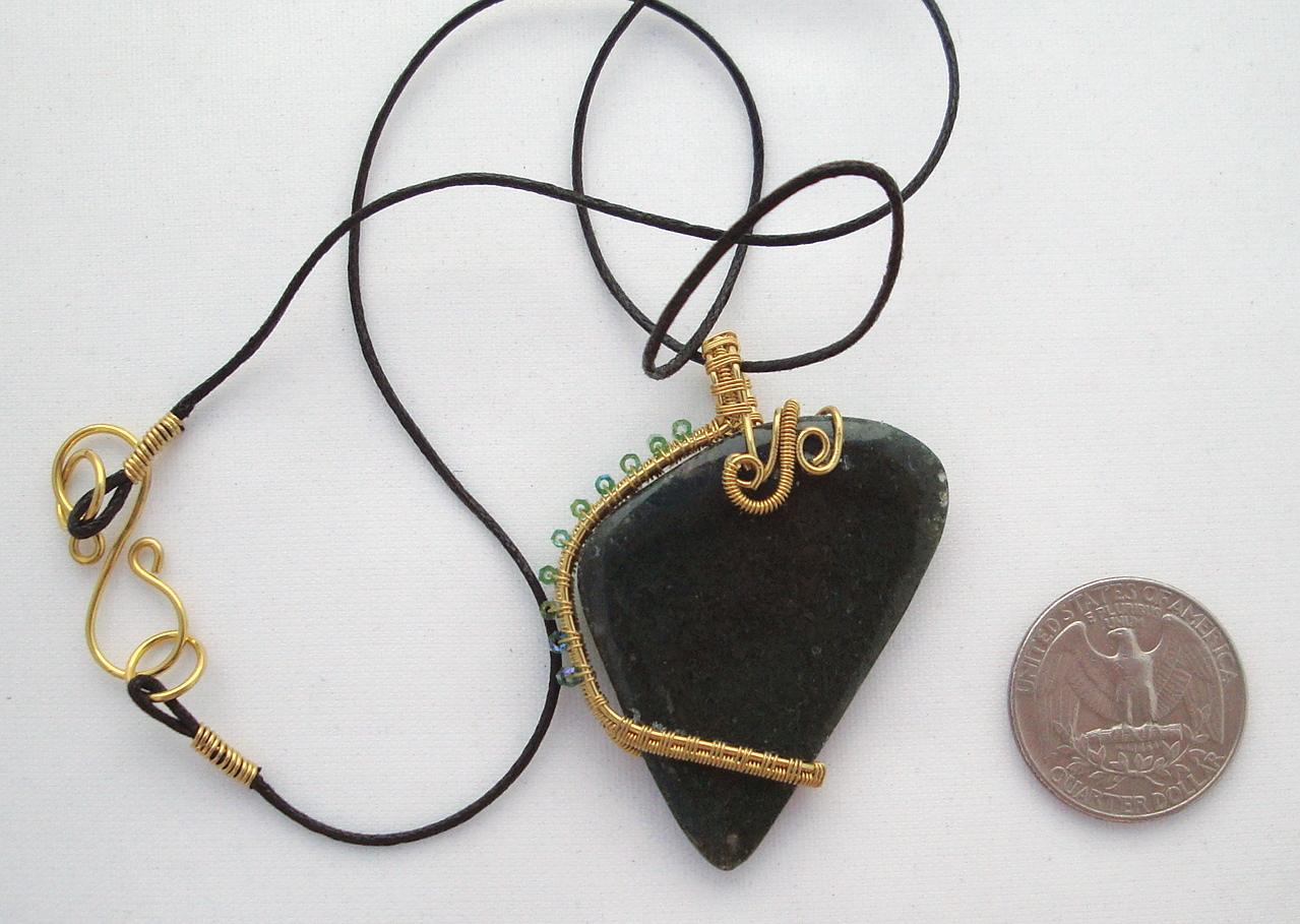 Dark green stone wrapped with bronze wire