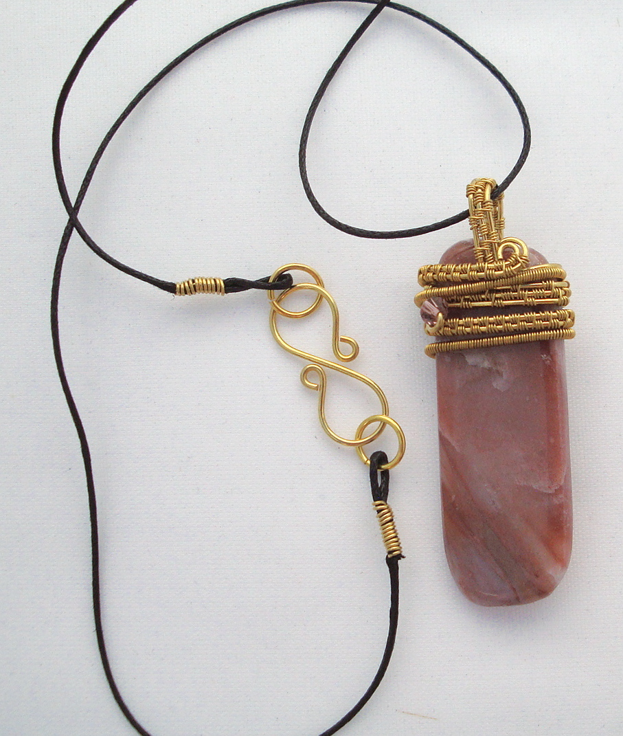 Pink striped stone wrapped with bronze wire