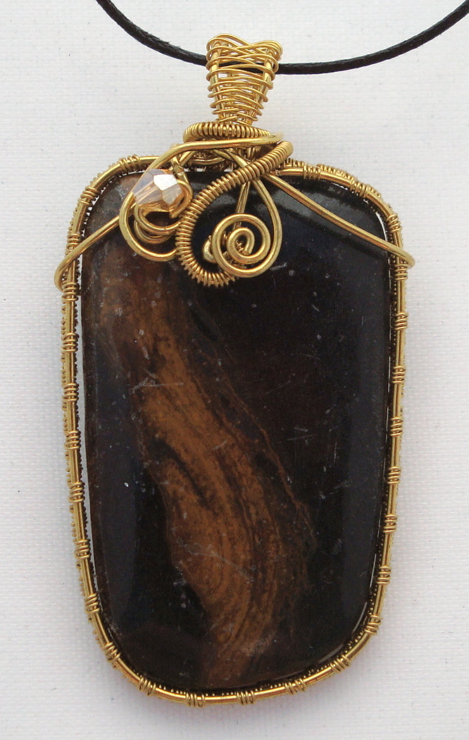 Black stone with brown swirls wrapped with bronze wire