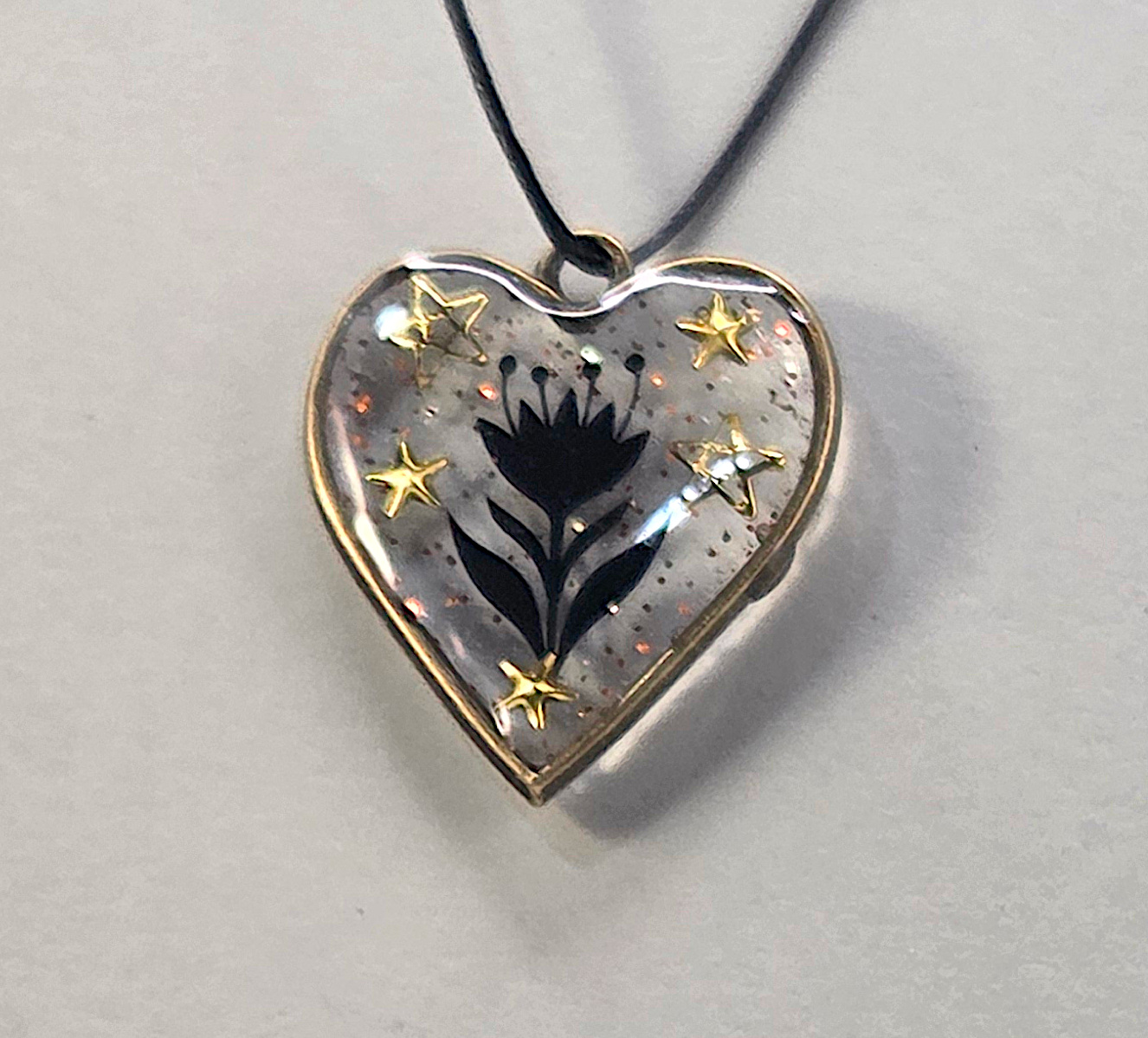 Resin pendants using antique bronze open bezels.