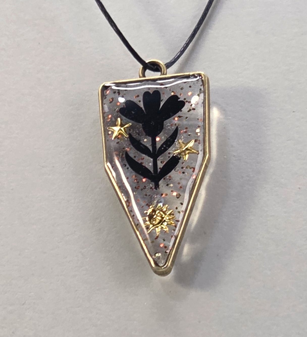 Resin pendants using antique bronze open bezels.
