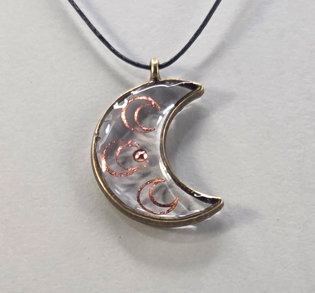 Resin pendant using moon shaped bronze open bezel.
