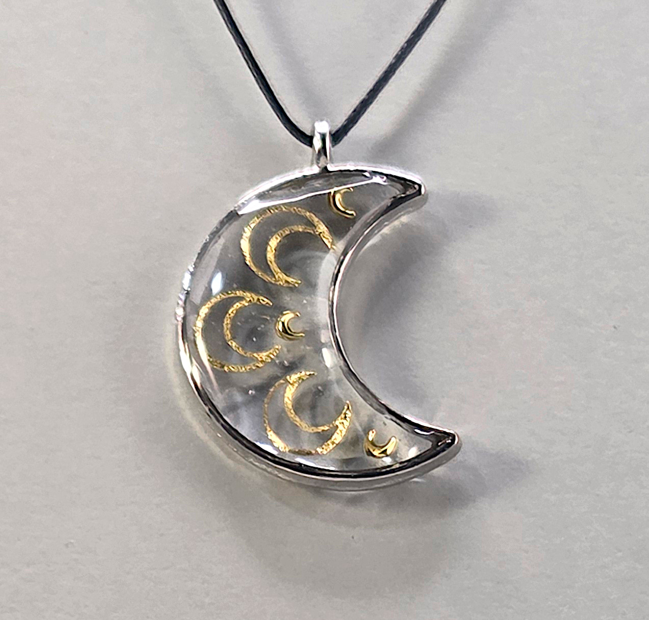 Resin pendant using moon shaped bronze open bezel.