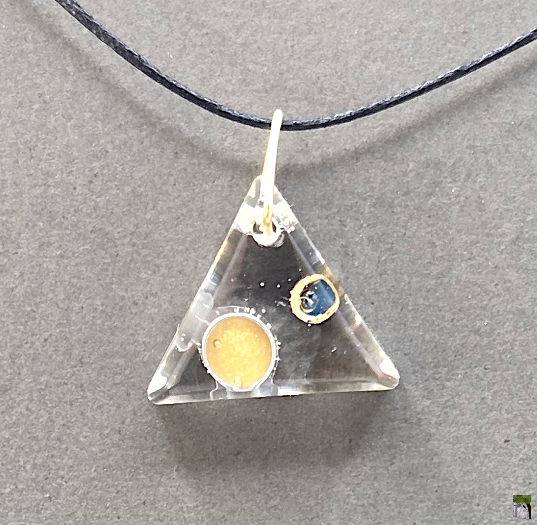 Small resin pendants with color inclusions.