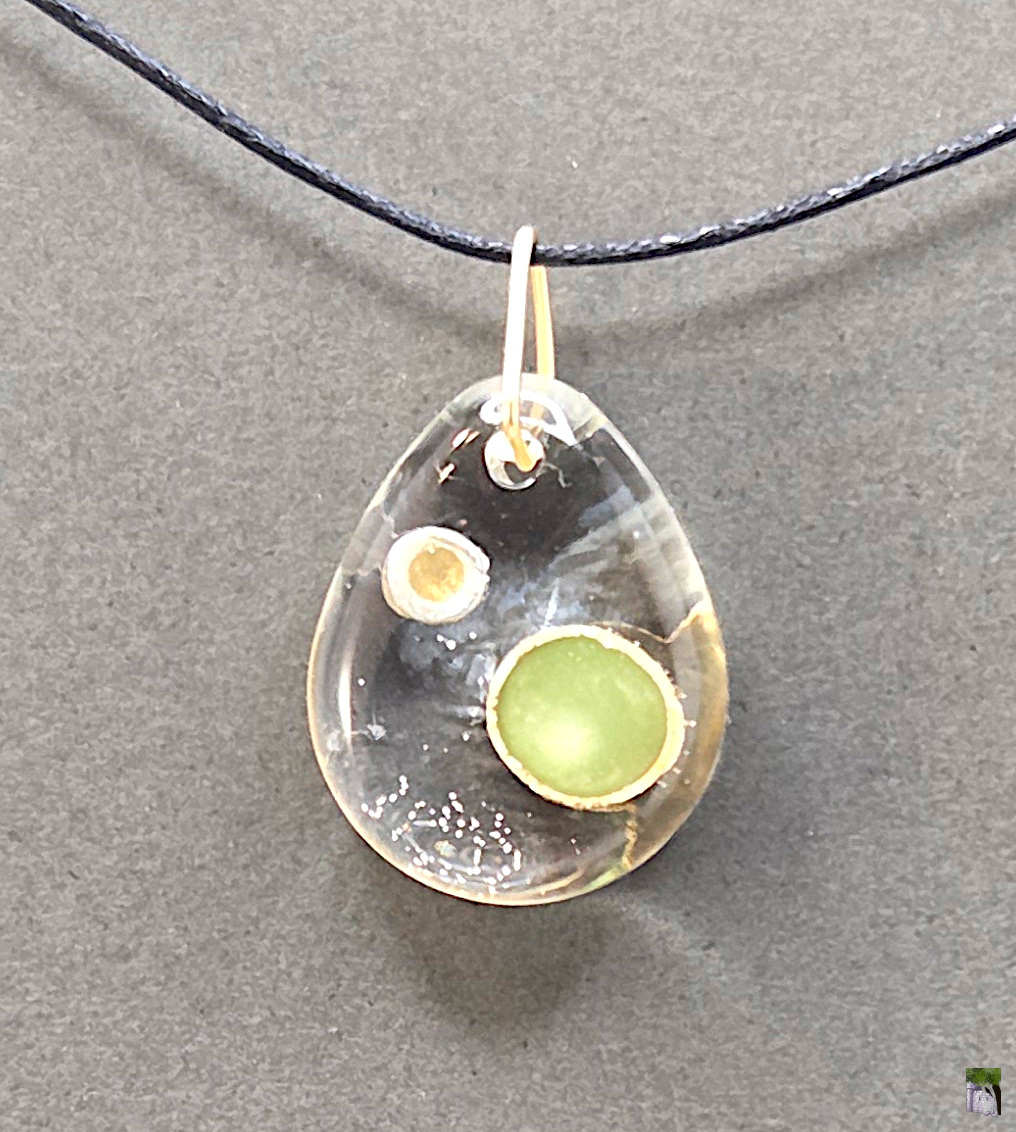 Small resin pendants with color inclusions.