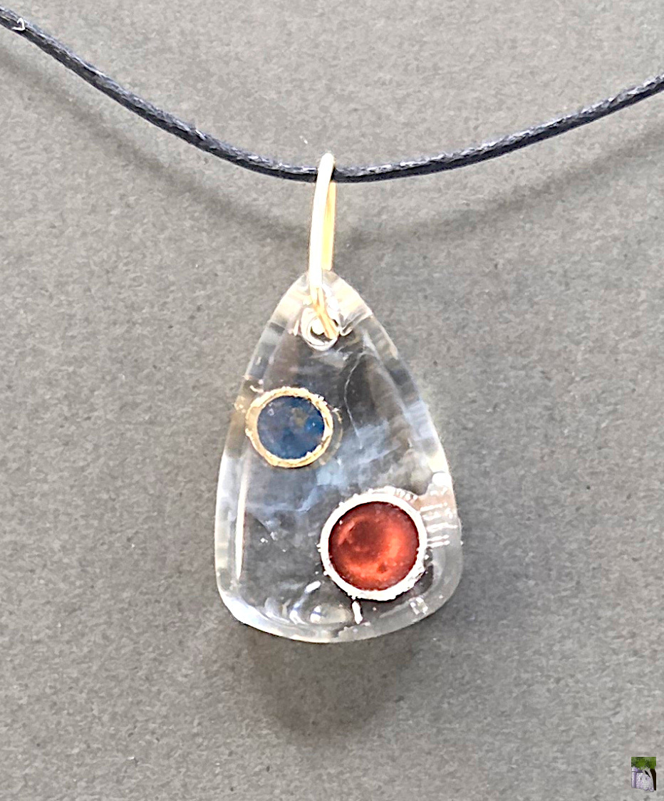 Small resin pendants with color inclusions.