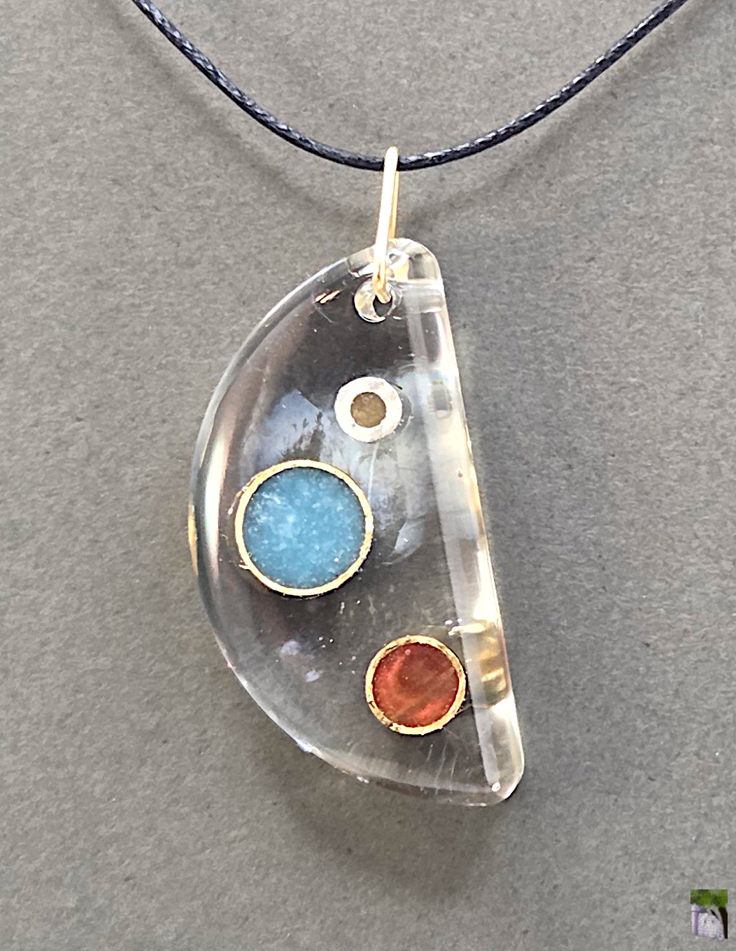 Large resin pendants with color inclusions.