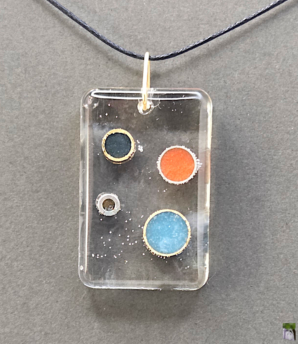 Large resin pendants with color inclusions.