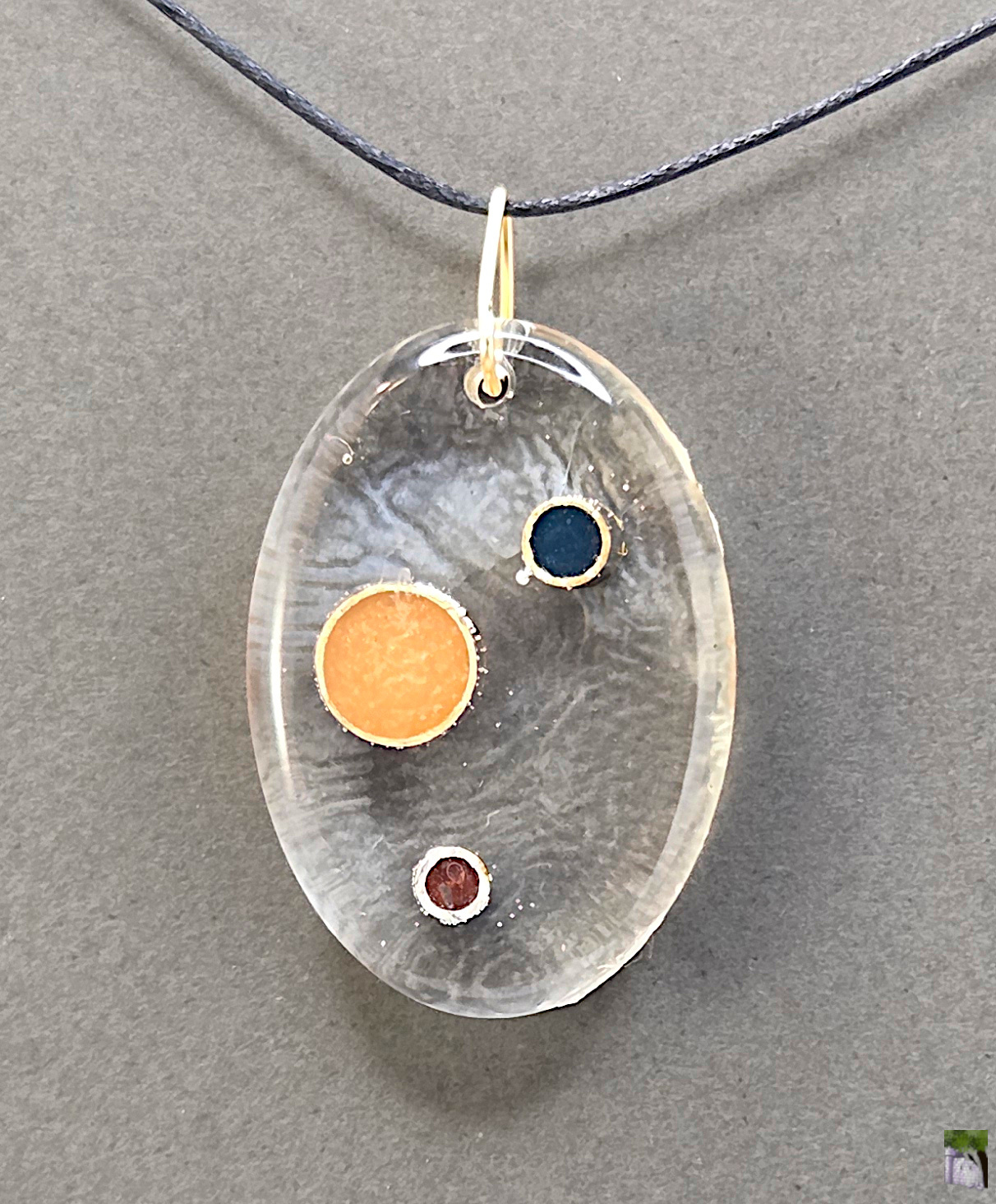 Large resin pendants with color inclusions.
