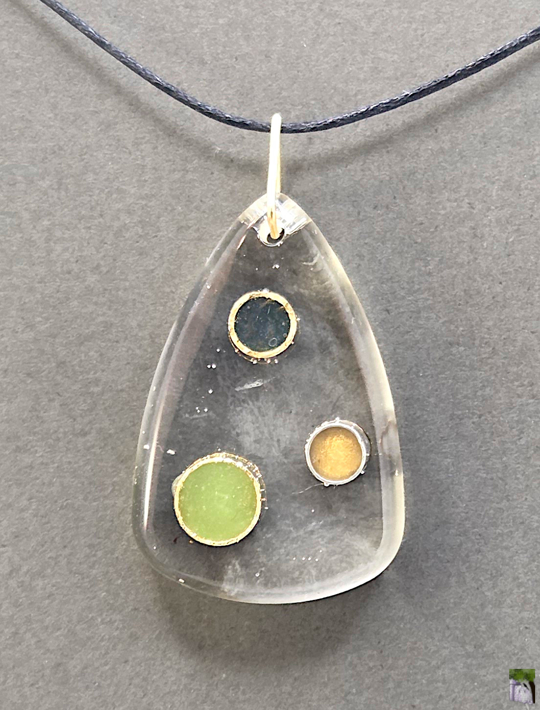 Large resin pendants with color inclusions.