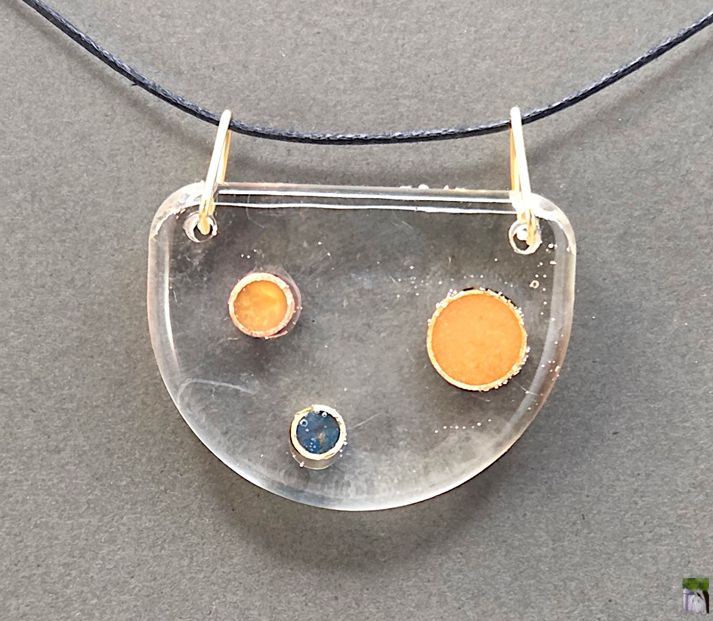 Large resin pendants with color inclusions.
