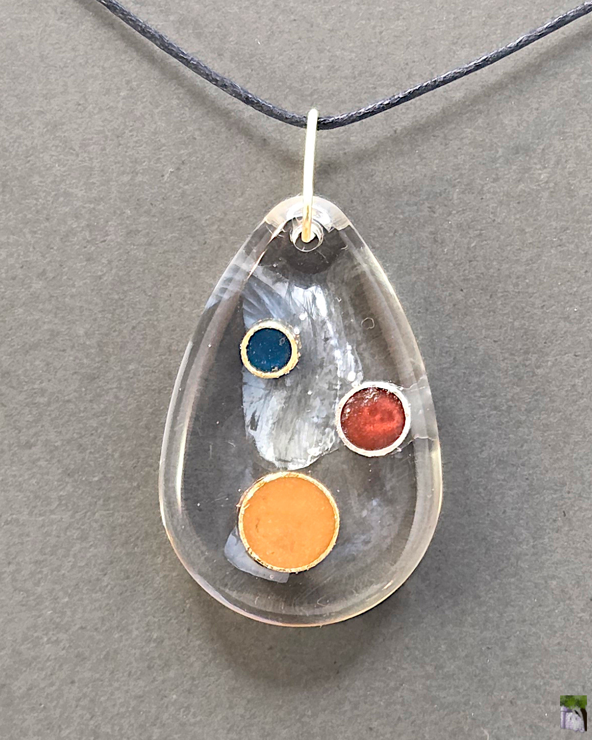 Large resin pendants with color inclusions.