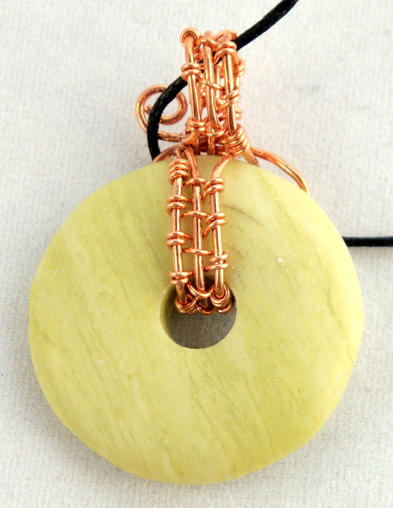 Stone donut pendent wrapped with copper 1