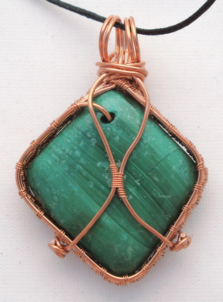 Green stone wrapped with copper wire