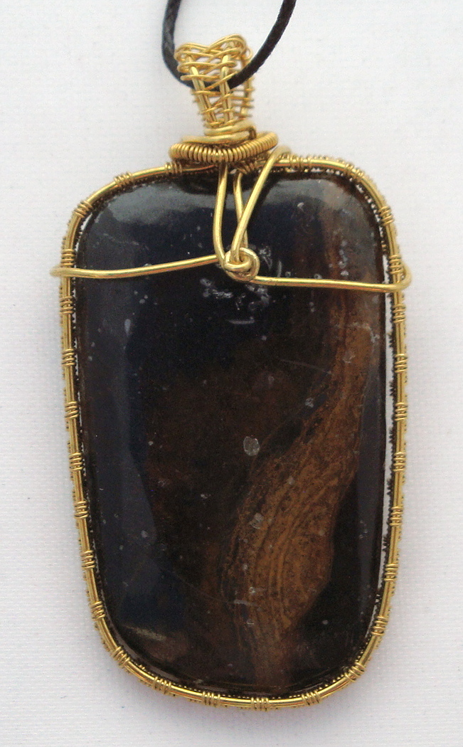 Black stone with brown swirls wrapped with bronze wire